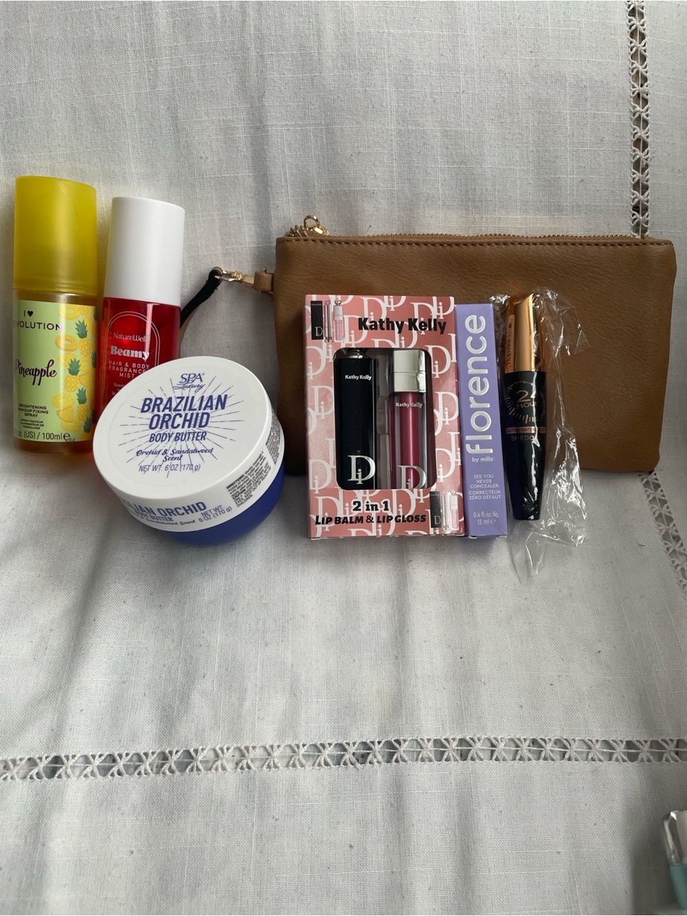 Revolution- Hand, Body, Eyes,Face,Lips Cosmetics With Tan Wristlet